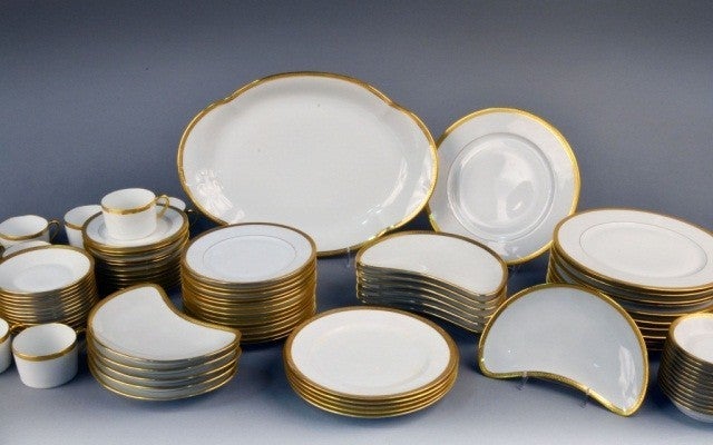 Porcelain dinner service in bone white with a gilt border by CH Field Haviland of Limoges. 

Charles Field Haviland left America for Limoges in the early 1850s to work originally for his uncle (David Haviland founder of Haviland and Company), and