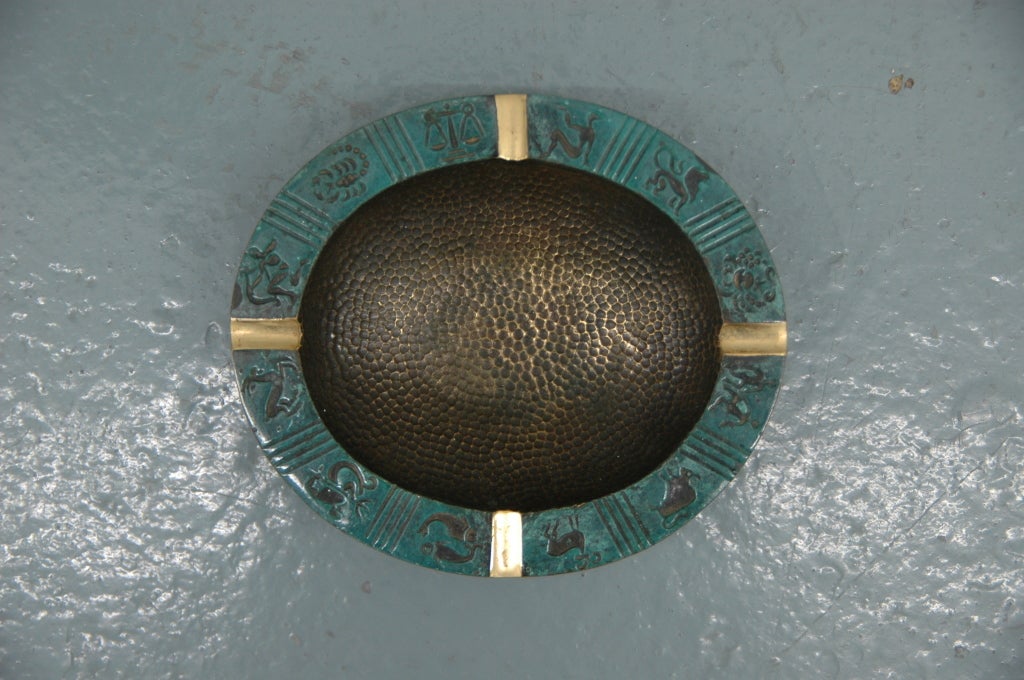 An interesting bronze and verdigris ash tray or dish with astrological signs surrounding the perimeter.