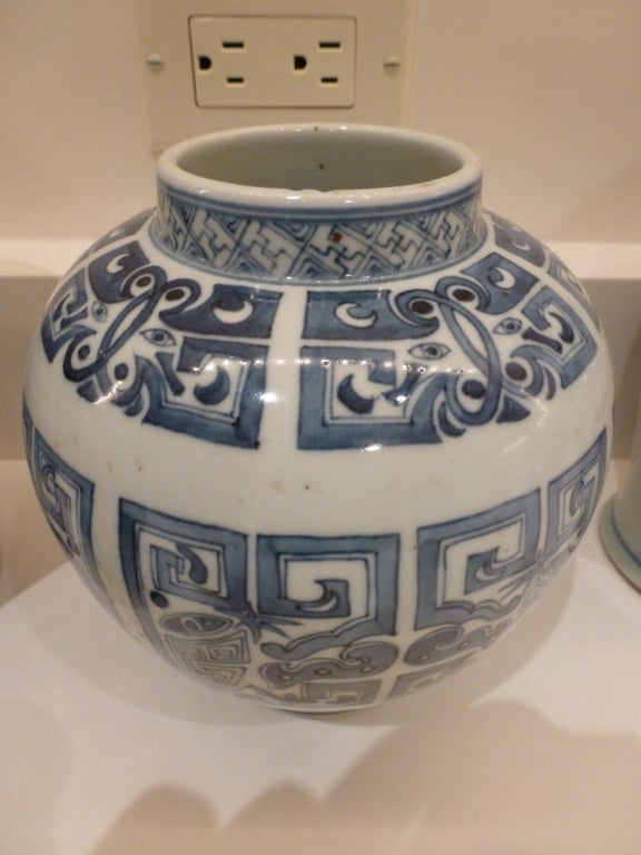 A vase with stylized bracket decoration.