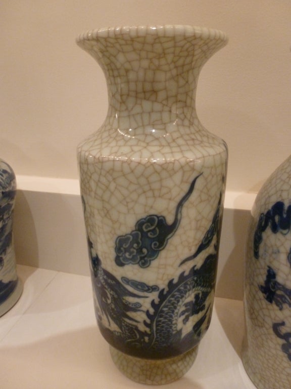 A set of four vases, two in a curved form and two of another cylindrical design forming a garniture.