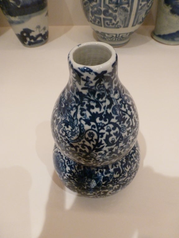A double gourd shaped vase with an overall blue and white foliate with peonies.