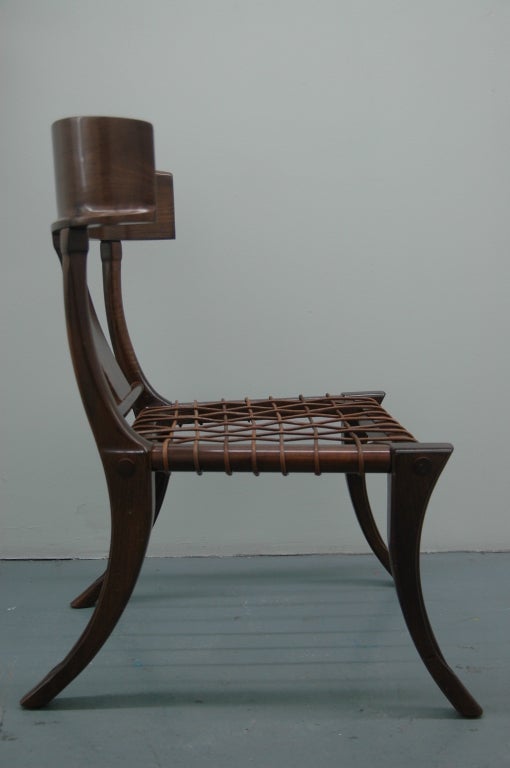 Walnut and leather-strapped klismos chair, finely constructed after the antique.

This is the klismos design by T.H. Robsjohn-Gibbings in collaboration with Greek cabinetmakers Susan and Eleftherios Saridis, based on antique Greek & Roman