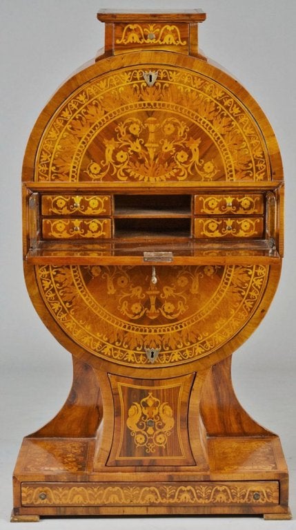Biedermeier style oval secretary cabinet with fall-front desk. 

Intricate inlay, good proportions.