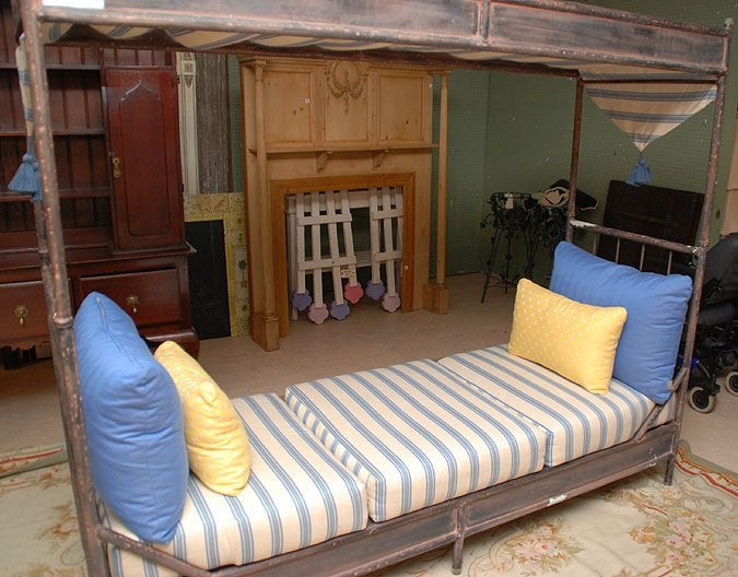 A unique daybed with a welded pipe frame and canopy.