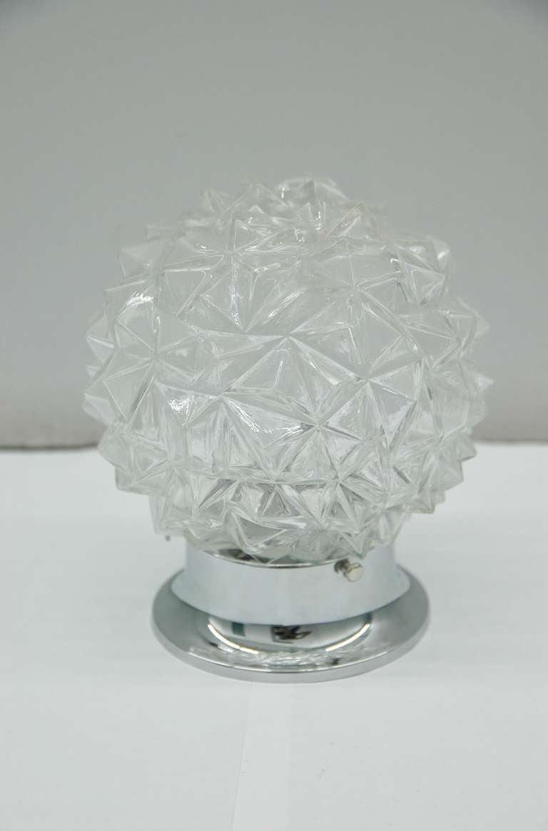 Set of two-light fixtures of molded glass globes to resemble faceted diamonds. Rewired.