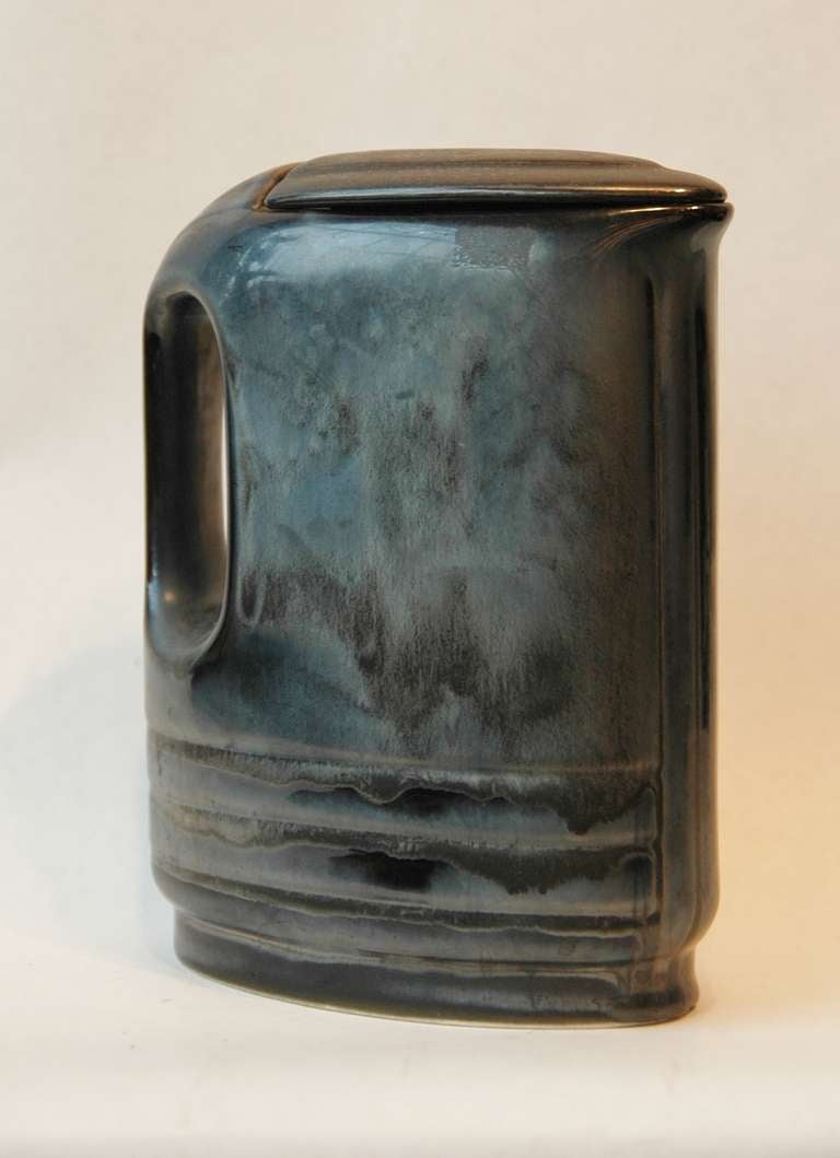 An interesting designed water pitcher with a lid in a beautiful black glaze.