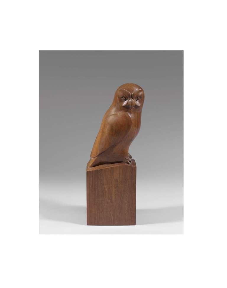 'Hibou' is a rosewood sculpture by François Galoyer of an owl. The tittle Hibou is French for owl. The sculpture captures the animals realistic appearance with some animated features such as the eyes and wings. This piece is signed