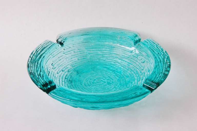 A beautiful ripple effect glass in a vibrant color serves as a candy bowl or ashtray possibly by Barovier and Toso.