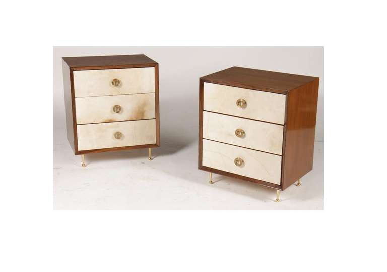 Two Italian commodes /Bedside tables in the style of Italian architect and designer, Gio Ponti. The pair is made of walnut with a parchment application on the face of each drawer and bronze hardware, including three rings pulls and tapered legs.