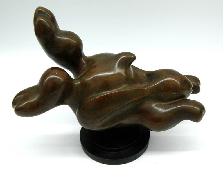 A heavy bronze sculpture of a racing rabbit on a rotating pedestal. The piece is signed 