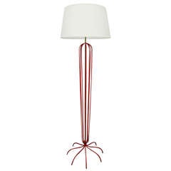 A Red Metal Floor Lamp In The Manner Of Jean Royere