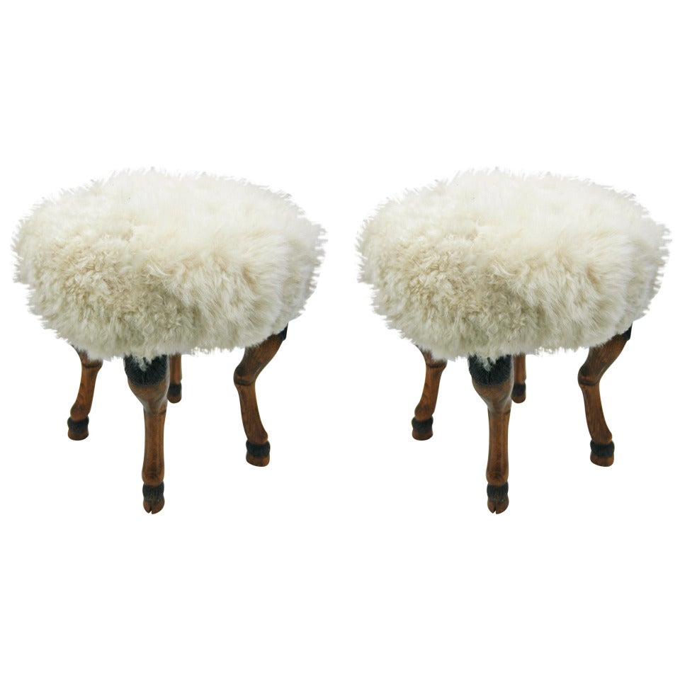 A Pair of Shearling Upholstered Stools with Hoof Feet