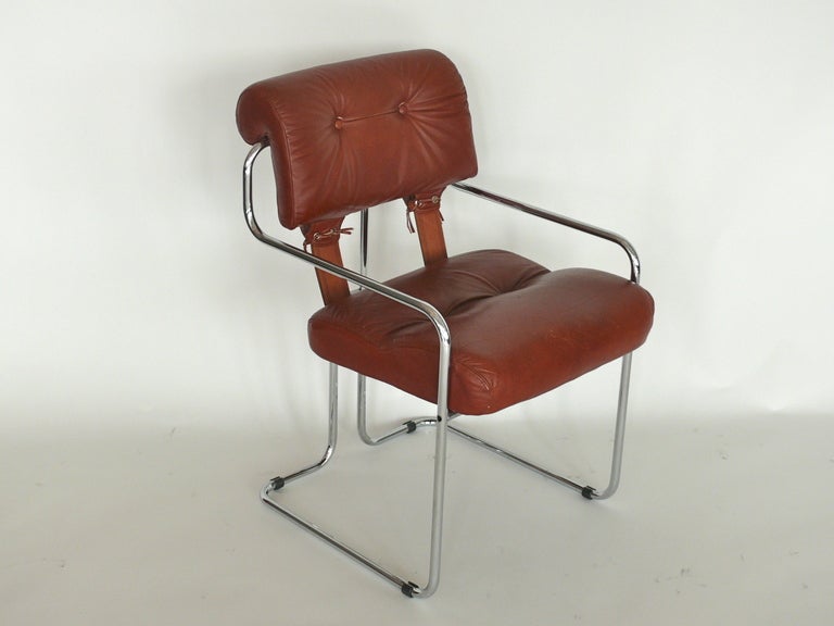 Mariani for Pace Collection dining chairs. Simple tubular chrome base with soft brown leather cushions. Fantastic leather corset detailing in the back with leather straps. Perfect desk chair. 2 available. Sold individually.