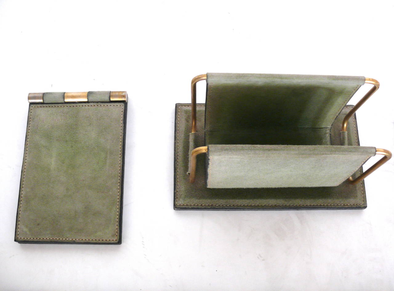 Fantastic desk set in green suede. Large trash can along with a mail holder, paper tray, ink blotter, writing pad, notepad holder, letter opener holder and rectangular box. Set in good vintage condition. Very unique color and set!