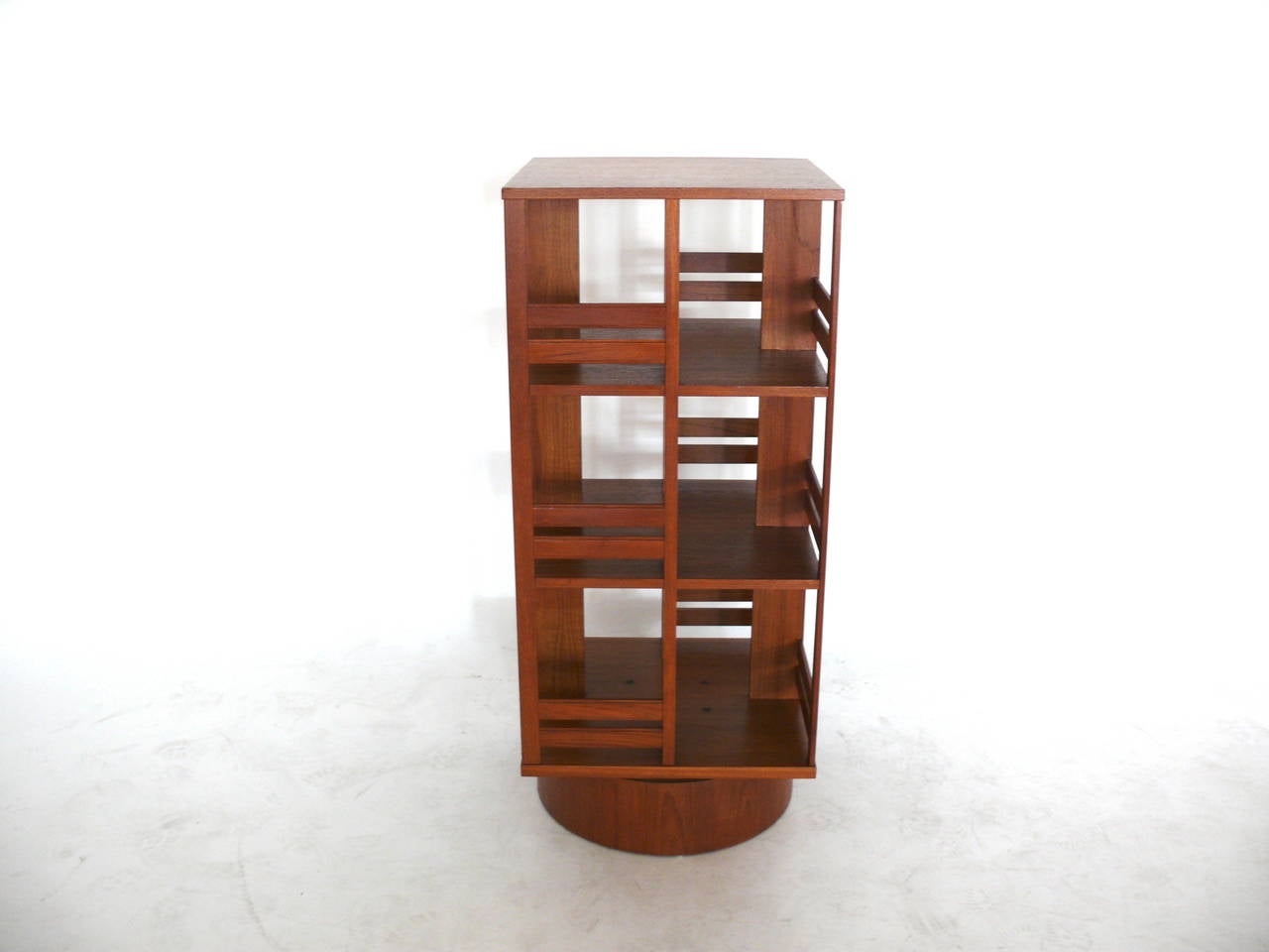 Handsome arts and crafts inspired bookshelf on thick mahogany base. 12 total compartments perfect for displaying books. Bookshelf revolves 360 degrees. Original vintage condition. Perfect for the library or kid's room.