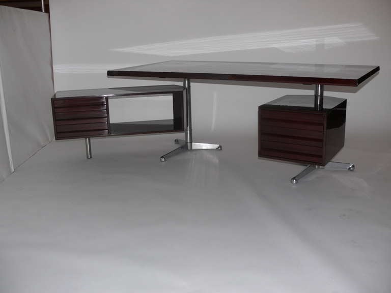 Rosewood Desk Designed by Osvaldo Borsani for Tecno. Newly re-finsihed rosewood with brushed stainless steel legs and adjustable drawers on both sides. Floating top and side storage add to unique and incredible design.