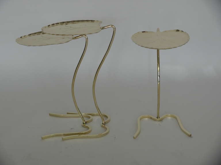 Fantastic pair of nesting tables by John Salterini. Lily pad formed tables rest on slim curved stem and base. Newly polished brass finish. Beautiful set for any room! Single smaller lily pad priced individually or as part of the set. 

Large lily