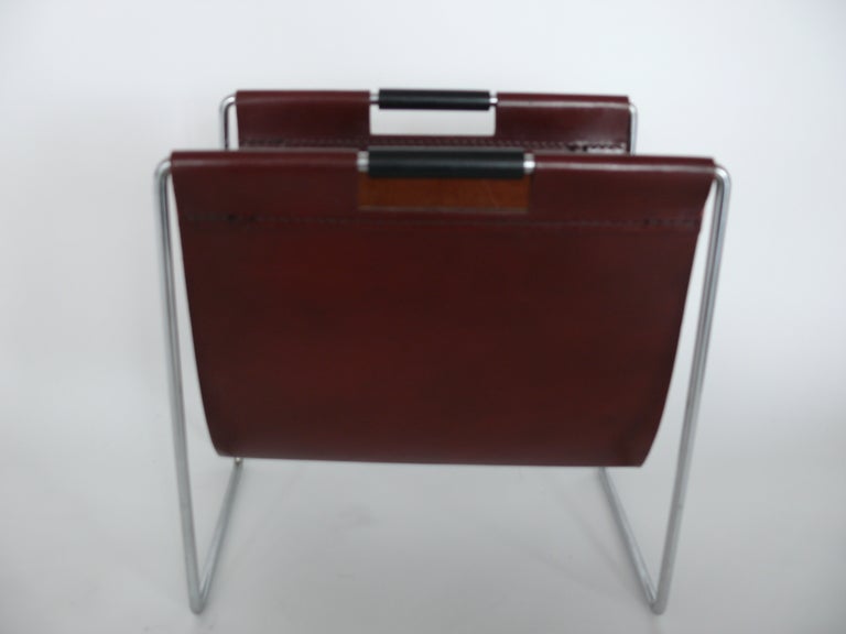 French oxblood leather and chrome magazine rack. Nice age to the leather, clean chrome, and black wood handle detail. Clean, elegant design and fantastic yet functional accent piece.