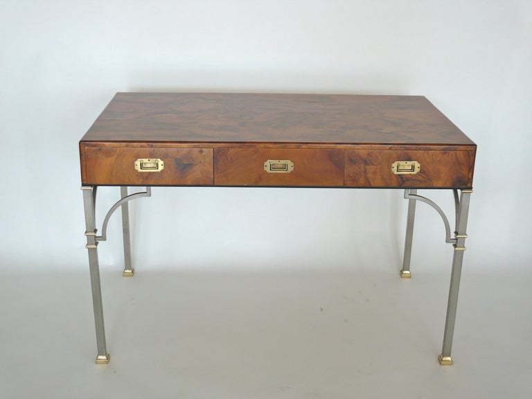 Beautiful olivewood burl writing desk with brass and nickel bamboo legs. Three drawers for storage with brass campaign handles. All original. Perfect writing desk or work space.
