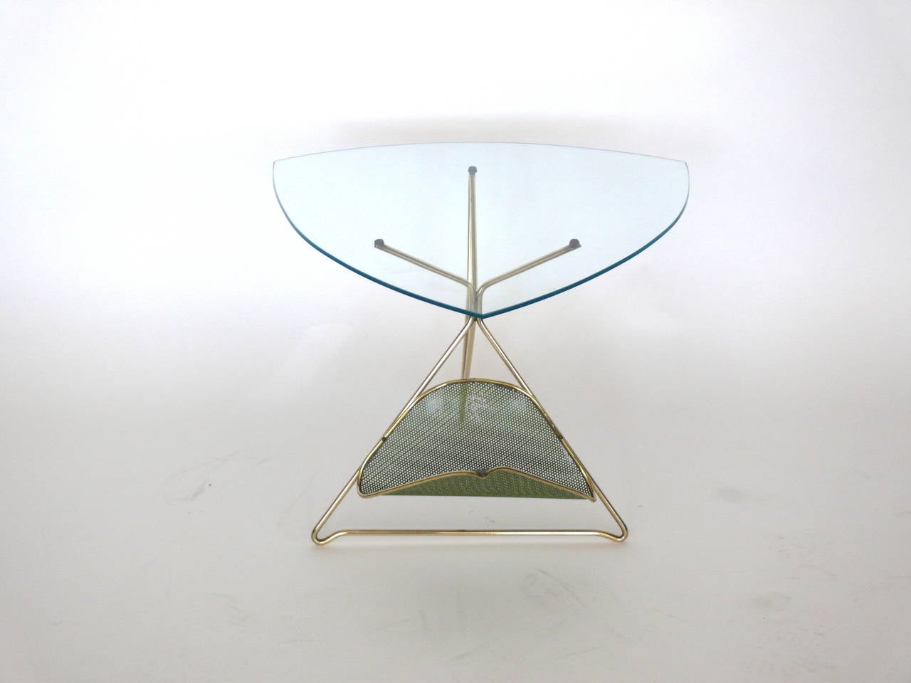 Handsome French side table by Mathieu Matégot. Brass and perforated metal table with triangular glass top. Fantastic lines and beautiful design. Excellent vintage condition. 