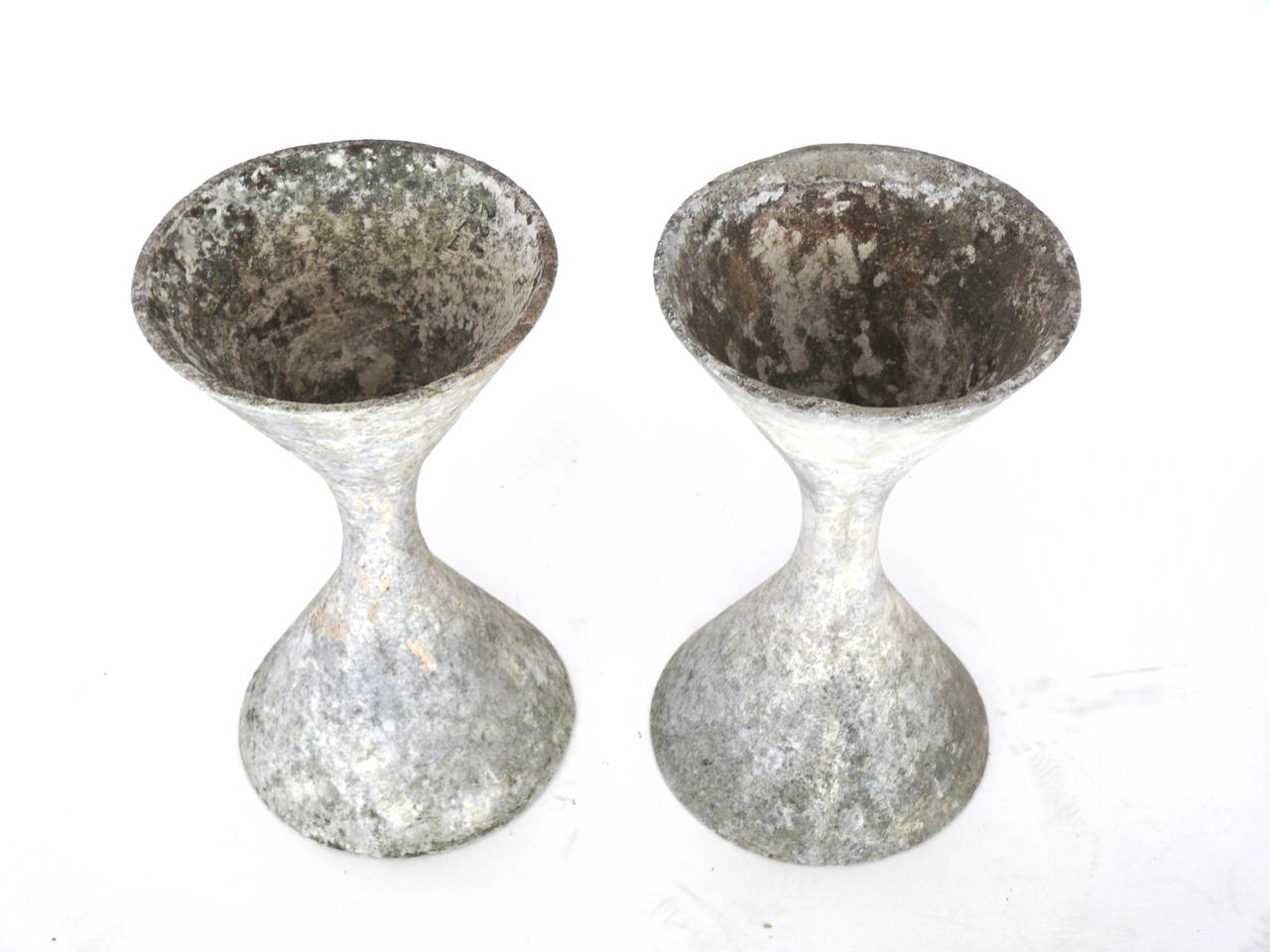 Fantastic pair of concrete hourglass planters by the Swiss Architect, Willy Guhl. Great age, patina, and coloring. Iconic sculptural planter or garden object. Priced as a pair.