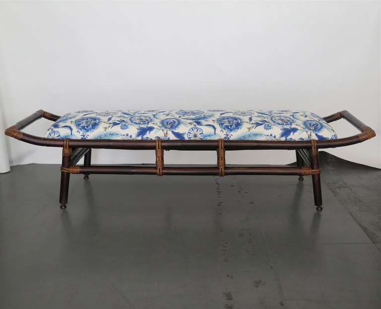 Beautiful vintage bench made of bamboo with rattan wrapped corners. Slender  seat with great low profile. Newly upholstered with blue oriental floral motif. Great for end of bed or entry way!