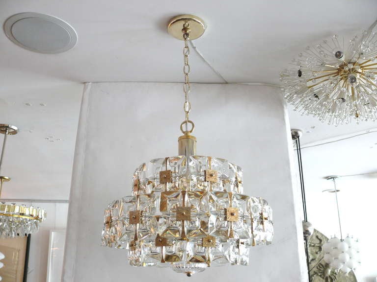 Beautiful geometric Palwa chandelier with rows of square shaped glass in clusters of four with brass square hardware in the center. Pretty glass flower like detail on the bottom.  Newly Rewired Pendant itself is 11