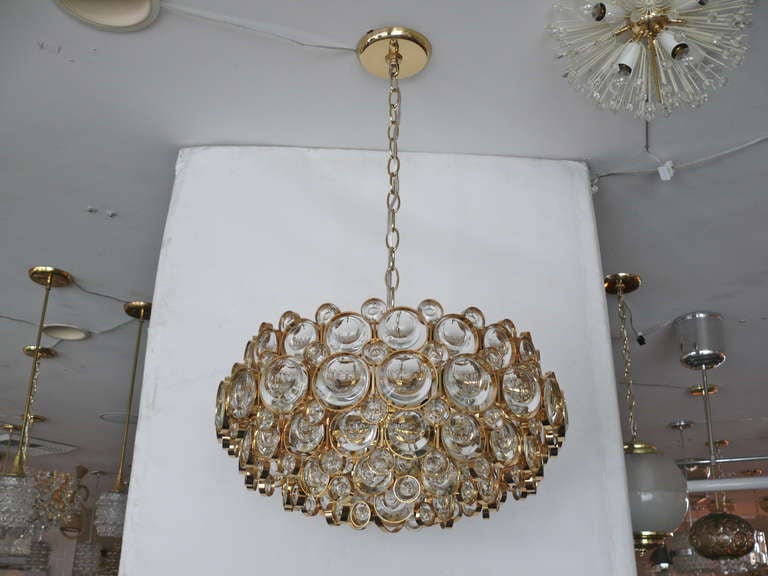 Stunning Italian Sciolari chandelier with individual jewel-like crystals surrounded by individual brass circles. Multiple tiers and sizes of crystals. Large scale and with exquisite detail. A breathtaking piece. 2 Available. Priced and sold
