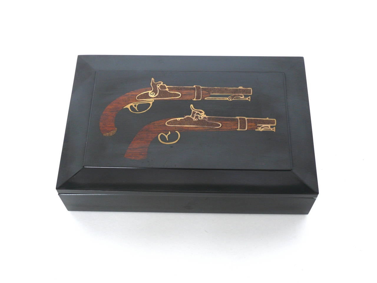 Handsome black box by Couroc of Monterrey. Box features two dueling pistols. Piece is in excellent vintage condition. Great object!