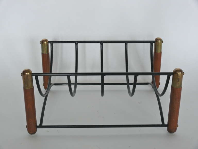 Unique wood and iron fireplace log holder.  Iron frame held by four vertical posts made of walnut wood and brass.  Beautiful patina and original finish adds nice character to the piece.