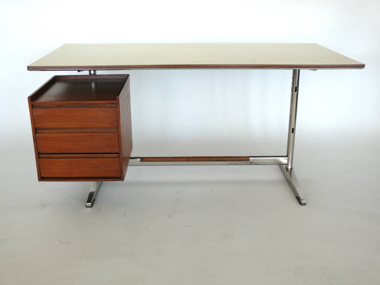 Fantastic writing desk by Fornaroli Rosselli for Studio Ponti. Desk was made in 1960 for the Pirelli skyscraper in Milan. Laminate top and ashwood floating pedestal with three drawers. Ashwood inlay on foot rest. Excellent vintage condition.