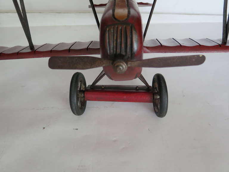 Fantastic vintage hand crafted wooden airplane. Great detail including original rubber wheels and rotating propeller. Great gift or whimsical addition to office!