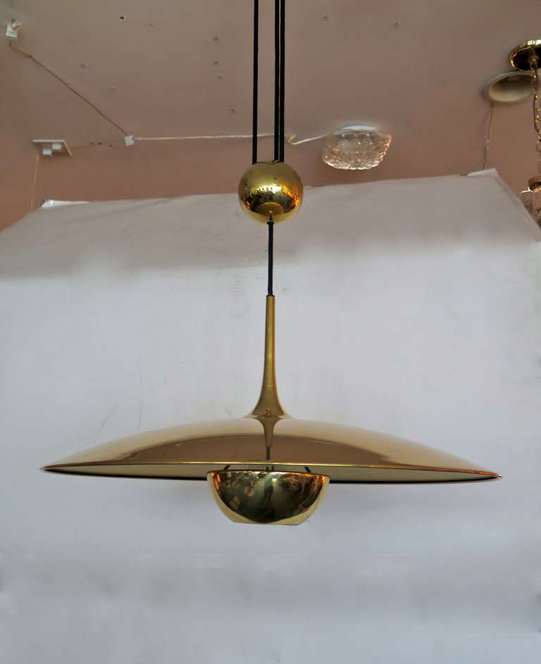 Beautiful Florian Schulz counter balance pendant in a polished brass finish. Professionally rewired, black cloth twist with a counter weight. Easily adjustable height. Absolutely stunning and rare design!