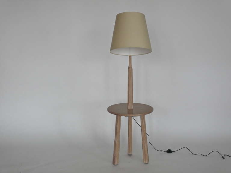 Great floor lamp in a beautiful light cerused oak finish.  Lamp features an angular arm that extends outward with new linen shade. Functional circular table that rests on a three legged base.  Perfect in between two chairs!  Newly rewired. Two