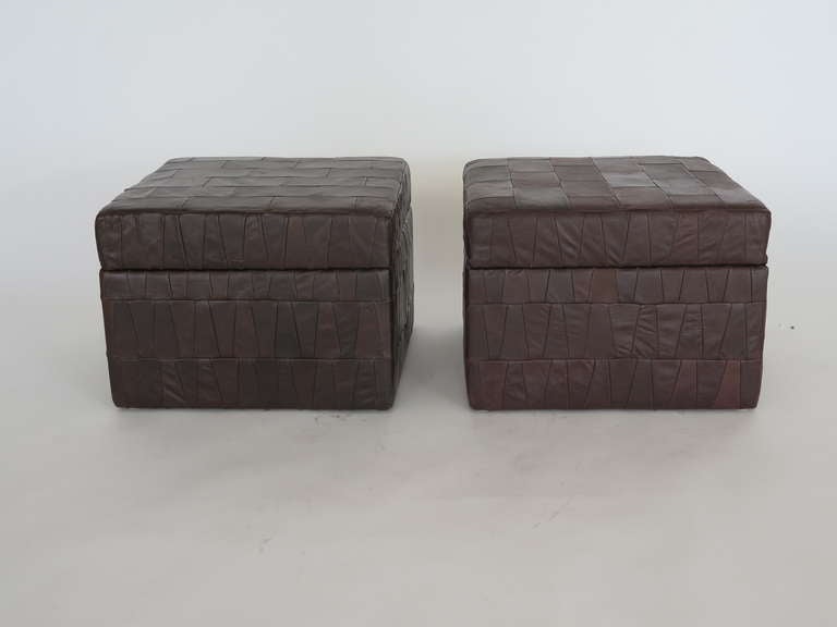 All original patchwork leather ottomans by De Sede circa 1970's. Beautifully broken in leather with great patina. Ottomans open to reveal a deep storage bin. Priced individually.