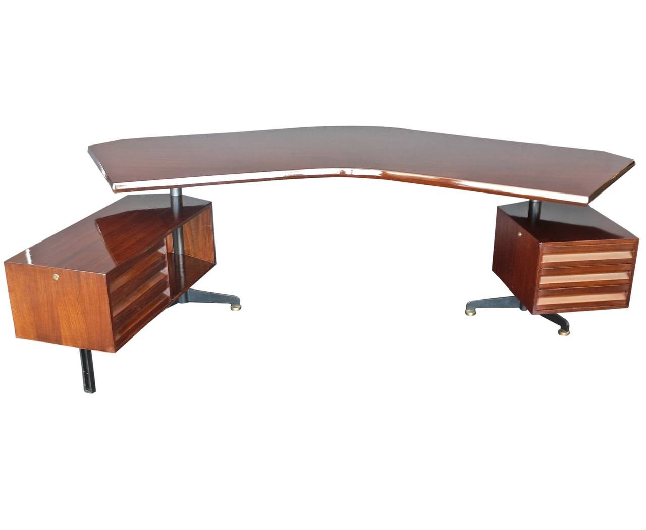 Incredible executive desk designed by Osvaldo Borsani for Tecno. Large rosewood boomerang top with black steel legs and floating adjustable drawers on both sides. Both the floating pedestal and long return swivel 360 degrees. Newly refinished to