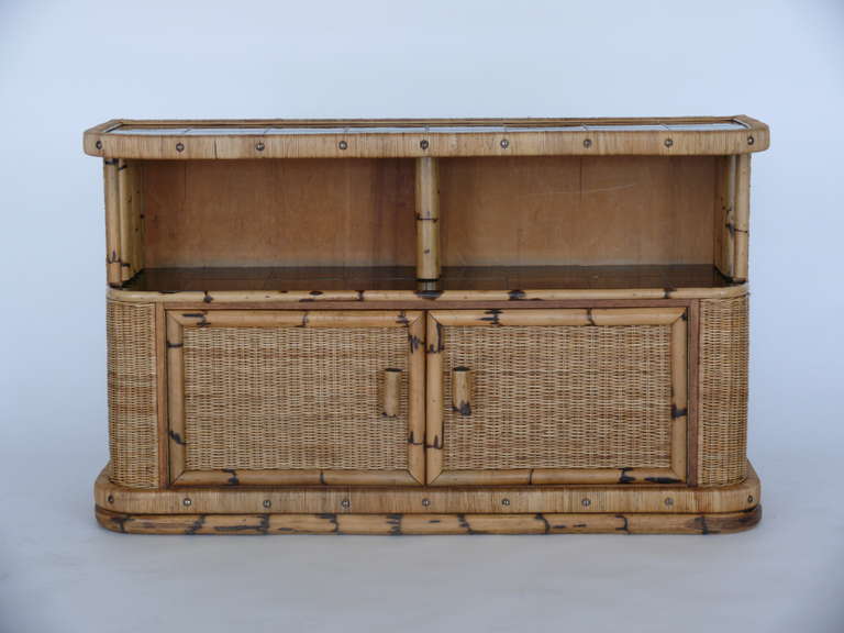 Fantastic bamboo, wicker and tile buffet by Mathieu Mategot. Impressive in size with plenty of storage. Two center cupboards with open shelving above. Black tile compliments bamboo structure well. A perfect piece for entertaining!