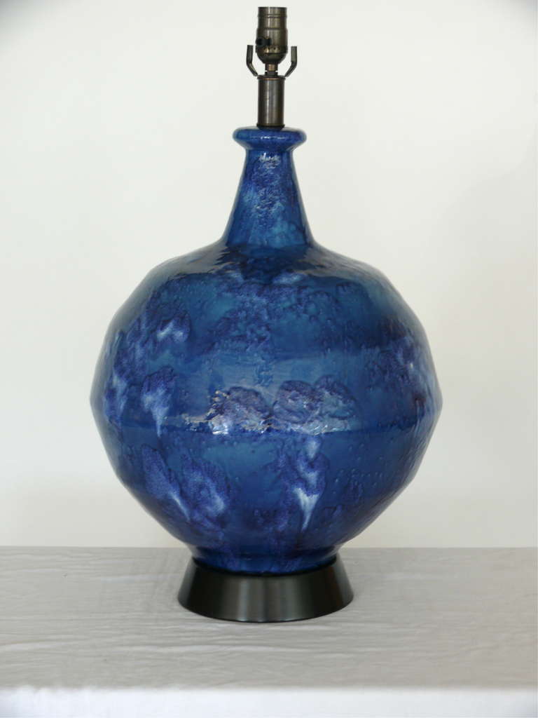 Fabulous pair of ceramic pottery drip glazed lamps with shades of deep blue. Each lamp rests on a black ceramic base. Unique glossy finish from top to bottom. Custom shades available for additional fee.