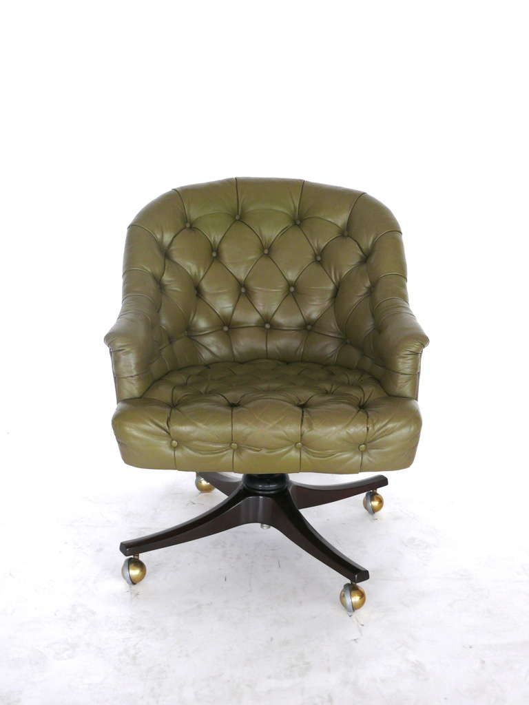 Tufted original hunter green swivel office chair by Edward Wormely for Dunbar. Wood base with brass casters. Minor scratches and wear consistent with age.
