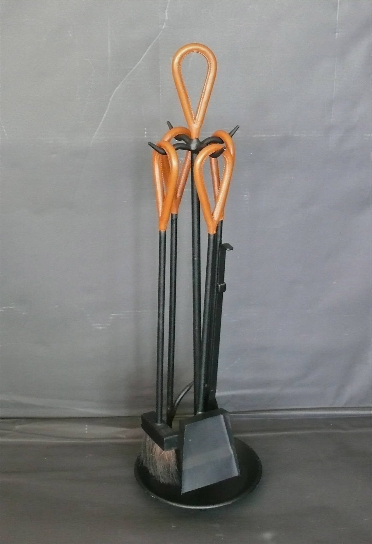 Handsome Austrian leather and iron fireplace set. Complete with dustpan, broom, poker and tongs. Set is in excellent vintage condition.