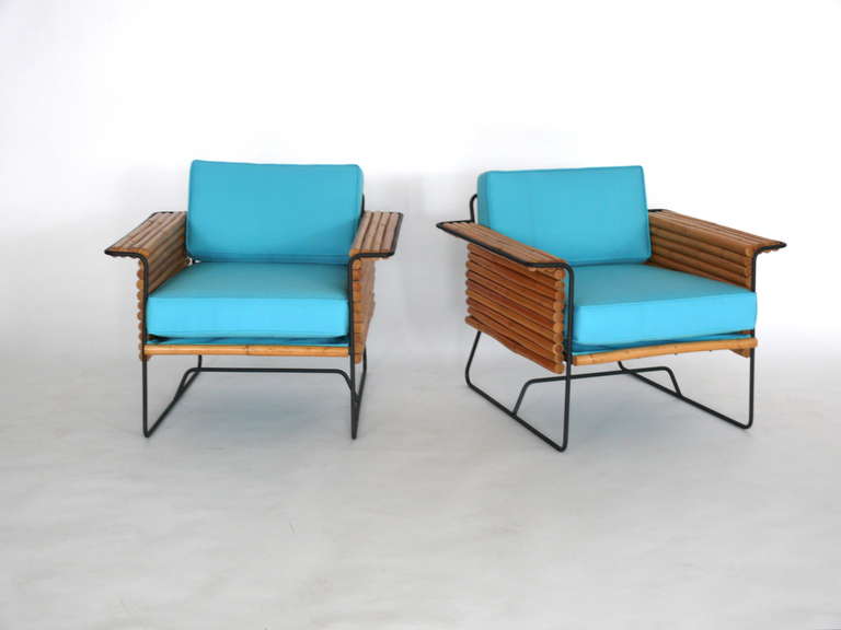 Stylish pair of bamboo and iron chairs designed by Herbert and Shirley Ritts. Newly upholstered teal cushions compliment the simple design and fantastic mix of materials. Herbert and Shirley Ritts are prominently know for their mid century modern