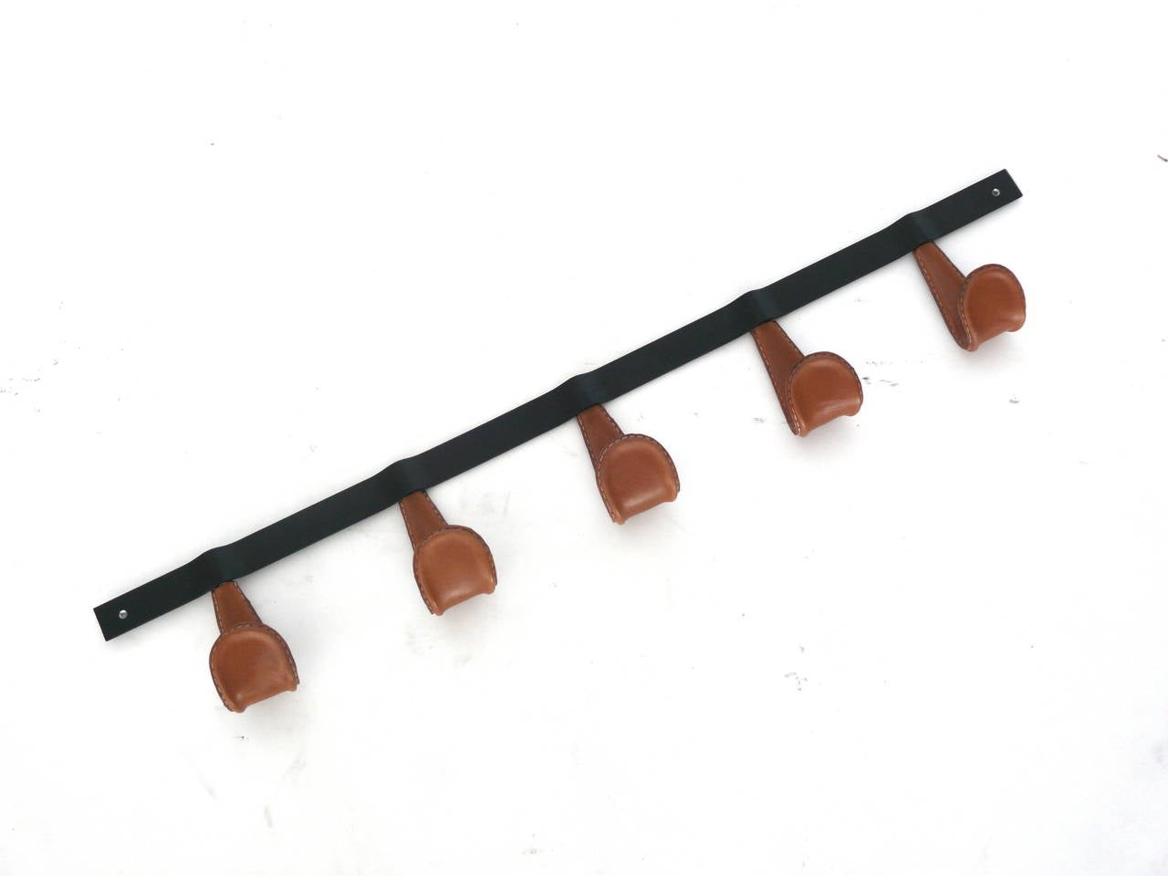 Newly produced iron and leather coat rack. Iron hooks wrapped in saddle brown leather with contrast stitching. Leather options available.