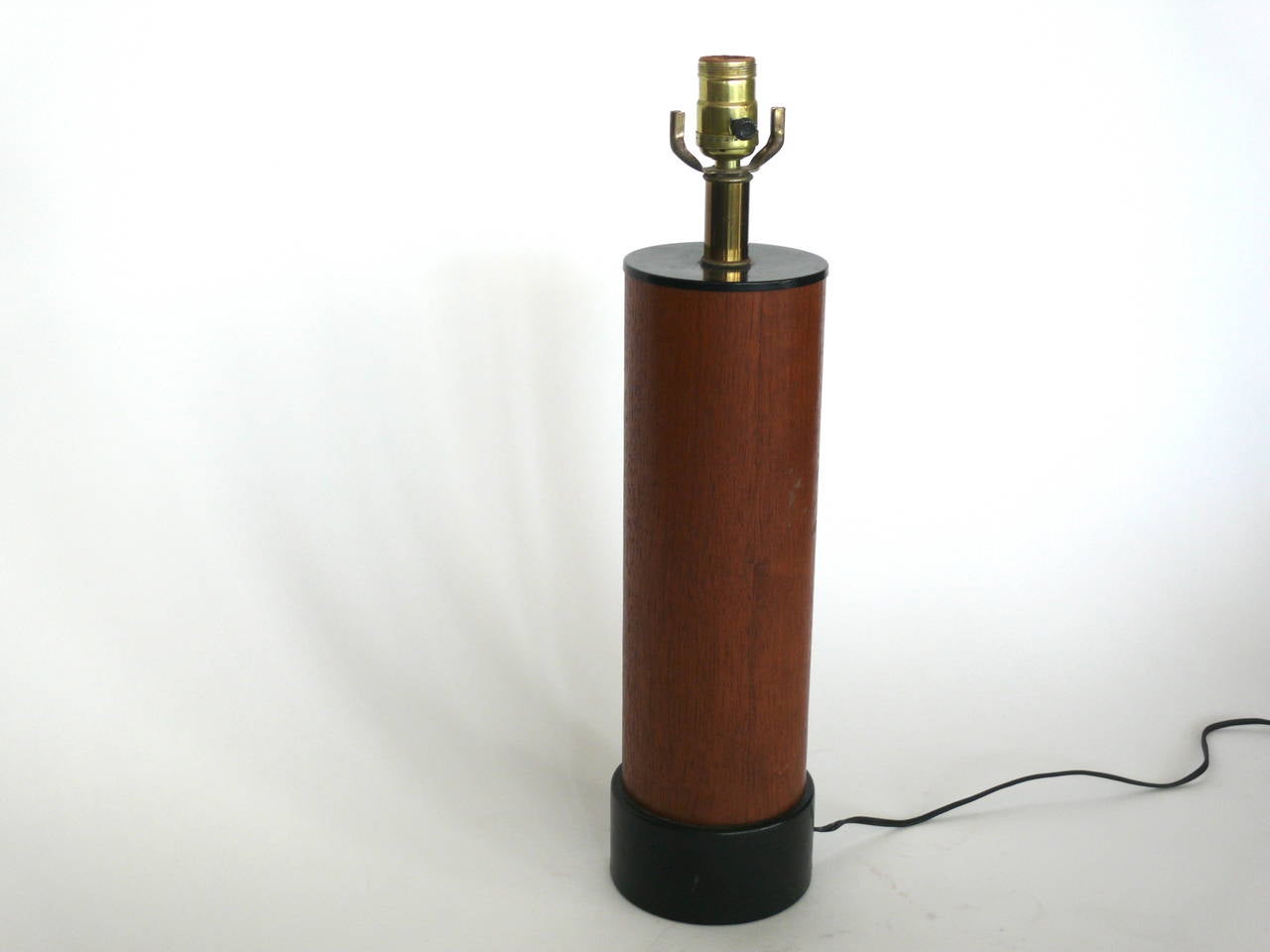 Handsome solid wood and leather lamp. Beautiful teak wood with black leather base. Newly rewired. Good vintage condition.