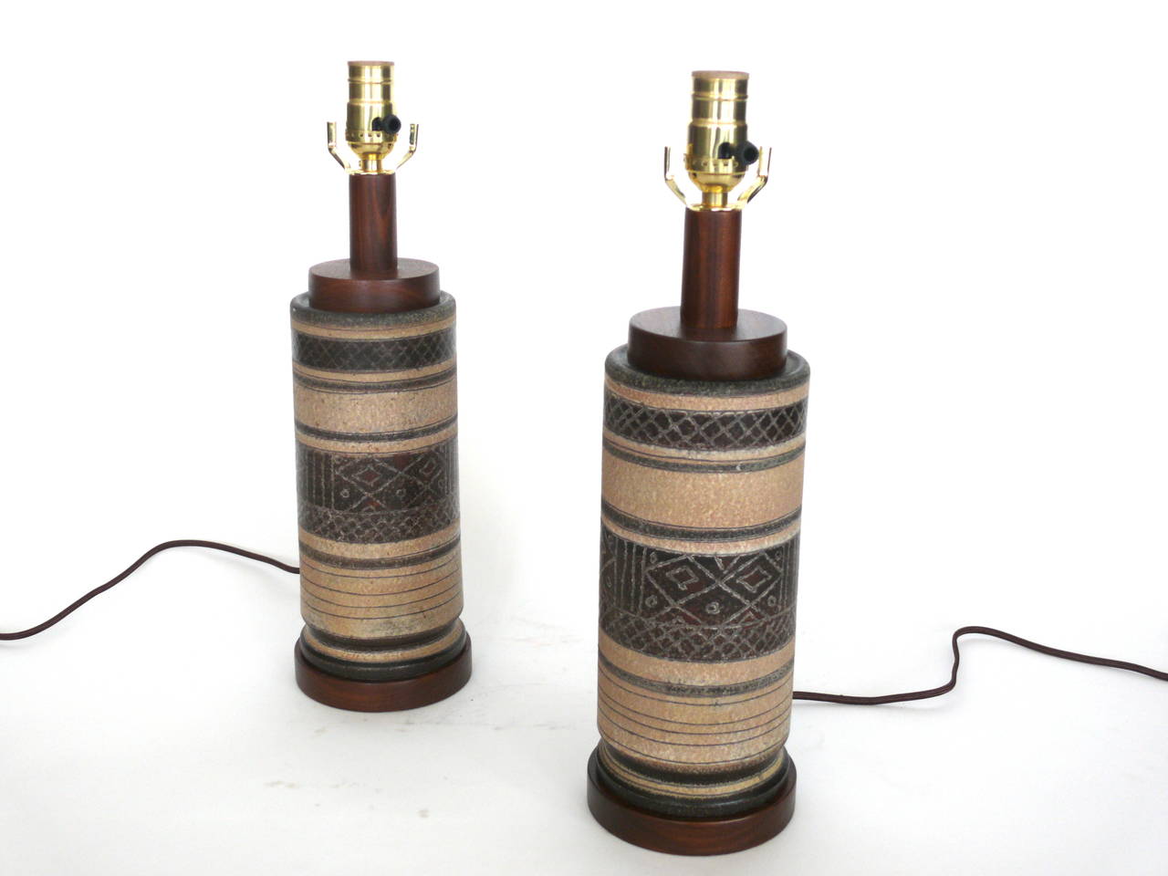 Fantastic pair of wood and ceramic table lamps. Great earth tones and pattern to lamps. Newly rewired. Excellent vintage condition.