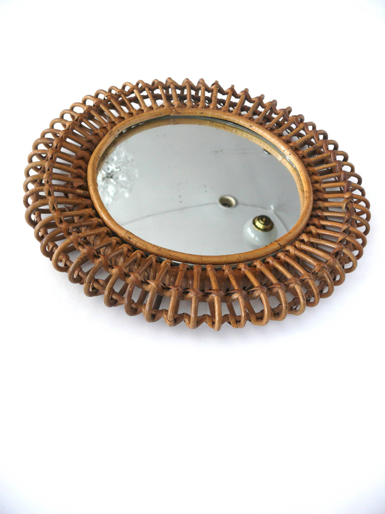 Incredible French bamboo and rattan mirror. Rounded bamboo and interlocking strands of rattan. Excellent vintage condition. Very unique.