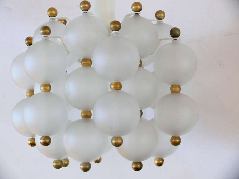 Beautiful chandelier with vertical hanging frosted glass globes and brass ball spacers by Kinkeldey. Interesting design with great scale! Newly re-wired.