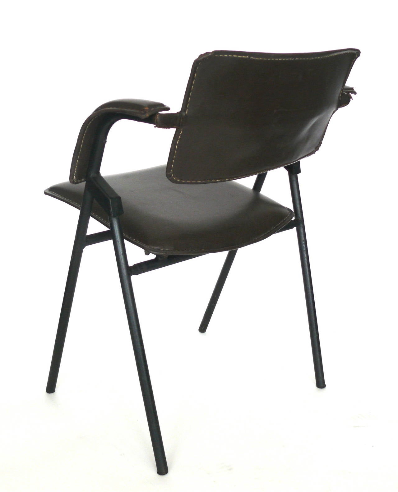 Great sculptural chair by French architect Jacques Dumont. Iron frame with black leather and white contrast stitching. Leather is in very good vintage condition with some blemishes and area where seam is opened. 