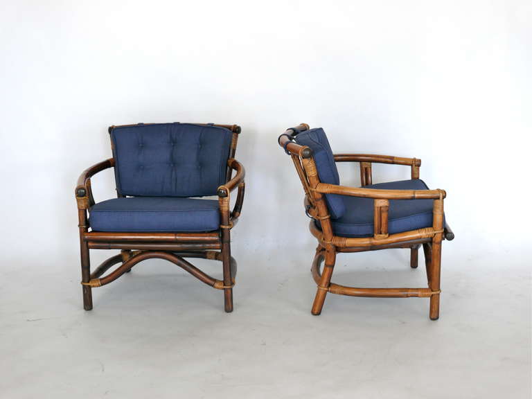 Great pair of bamboo and rattan armchairs by Ficks Reed Co. Newly upholstered navy linen cushions compliment the design and fantastic mix of materials. Great rattan wrapped detail throughout. Priced as a pair.