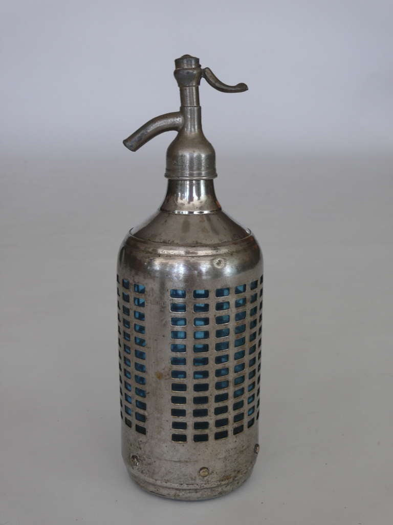 Incredible vintage glass and metal French soda siphon. Perforated steel sheath and gorgeous blue glass siphon. Stamped with the address 