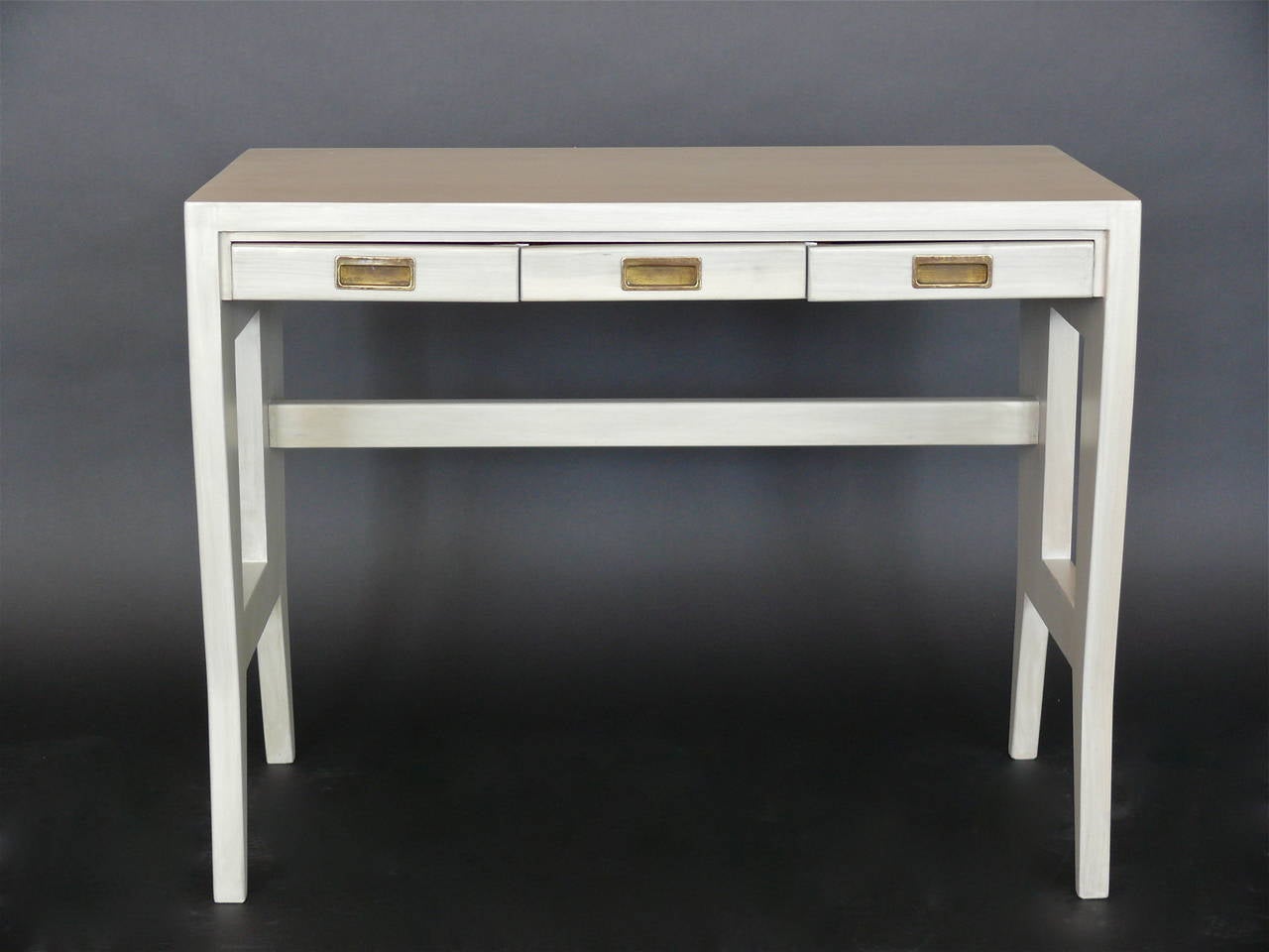 Incredible Gio Ponti desk from the University of Padua. Three pull-out drawers with beautiful brass detailing. Fantastic and functional size, would make an excellent writing desk, vanity, or console. A 1940 design for University of Padua, later